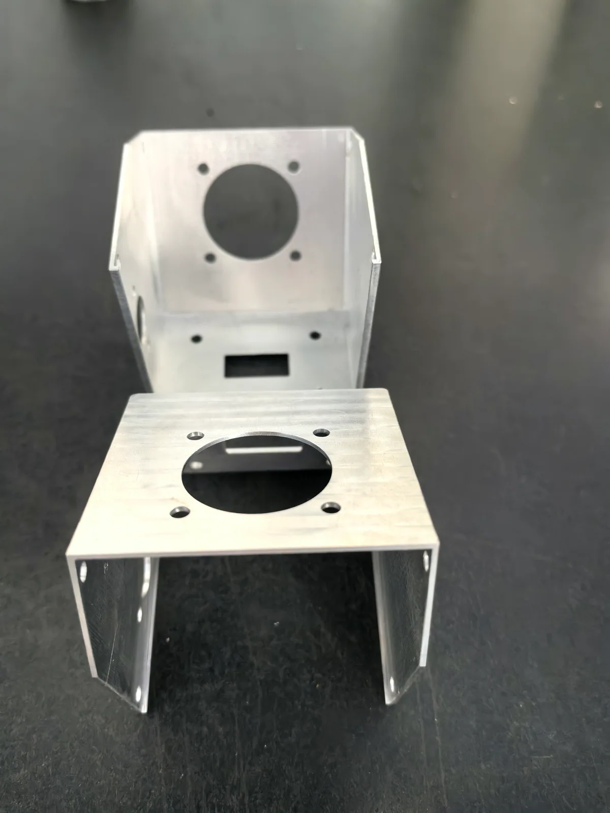 Alternate product view of thin-wall cathode brackets with a large circular opening and angled side sections