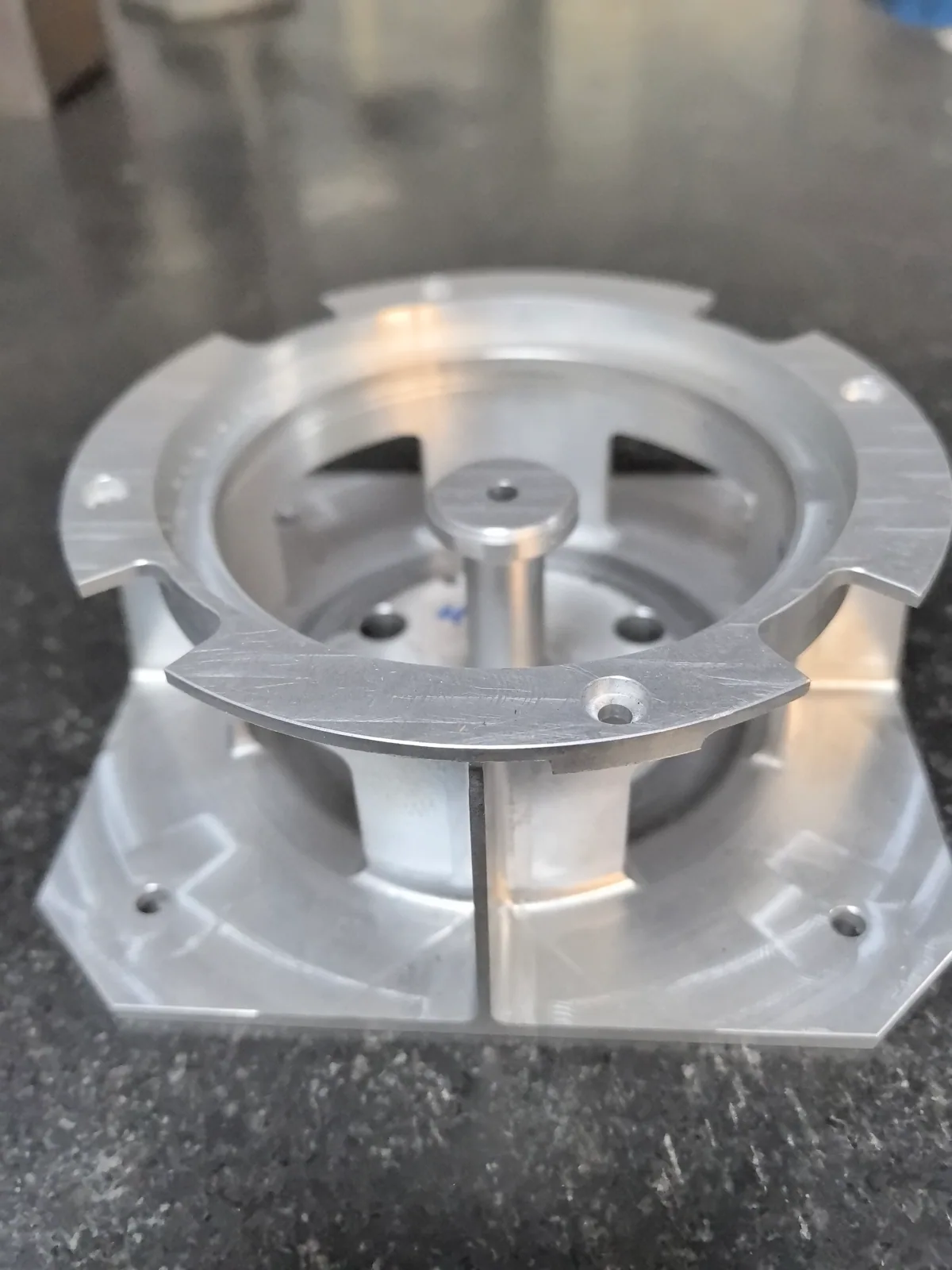 Upper ring and central post of the 2A12 aluminum component viewed from above at an angle